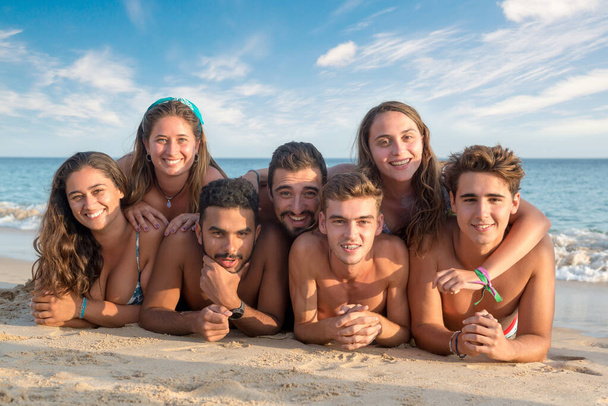 Gruppo di giovani felici in spiaggia - Foto, immagini