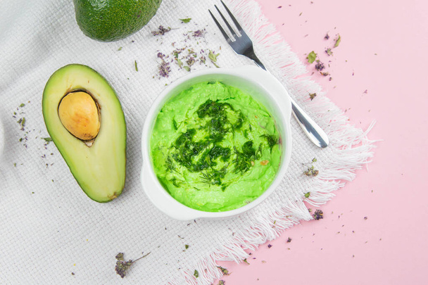 Curd with avocado and kiwi. Healthy eating concept. Assortment of products in bowls on pink background. - 写真・画像