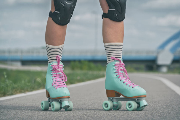 Woman rollerskater wearing knee protector pads on her leg - Fotografie, Obrázek