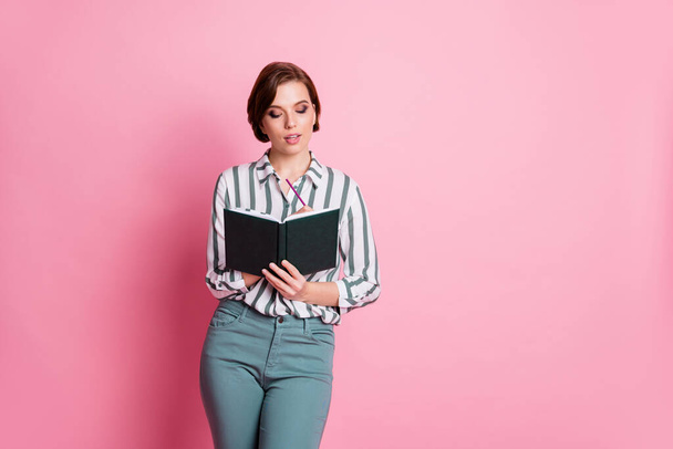 Portrait of focused intelligent girl write notes in copy book work worker on review wear stylish clothes isolated over pink color background - Fotografie, Obrázek