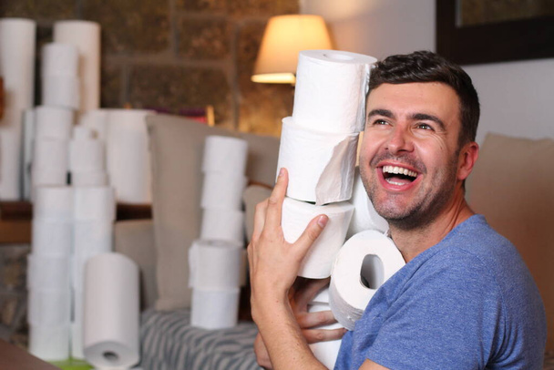 Man stocking up toilet paper at home - Photo, Image