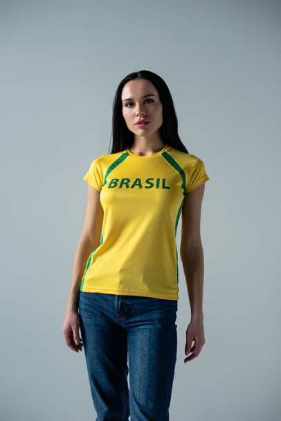 attractive football fan in yellow t-shirt with brazil sign isolated on grey  - Fotografie, Obrázek