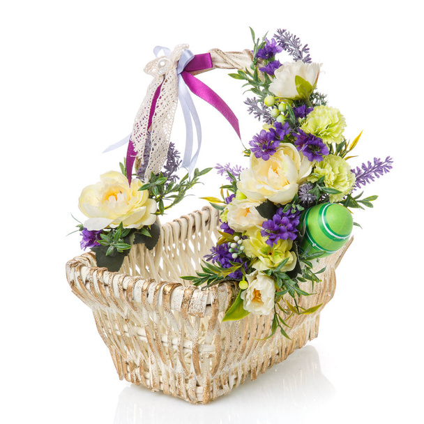 White and gold Easter baskets decorated with light flowers, eggs and colored ribbons on white background - Fotografie, Obrázek