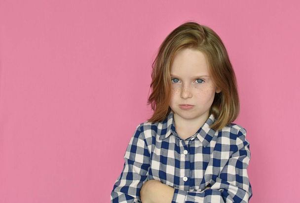 cute little girl in blue shirt isolated on pink background  - Foto, Imagen