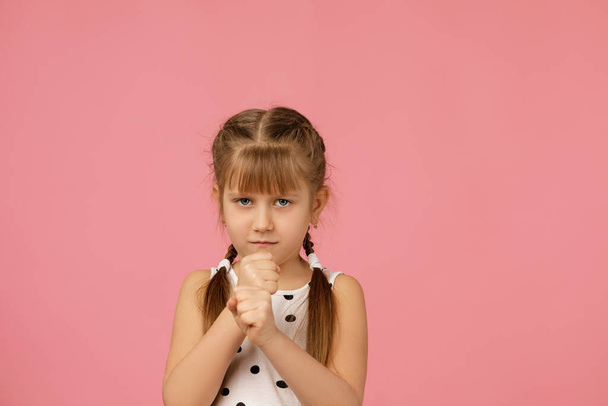 angry little child girl in dress raising fist - Фото, изображение