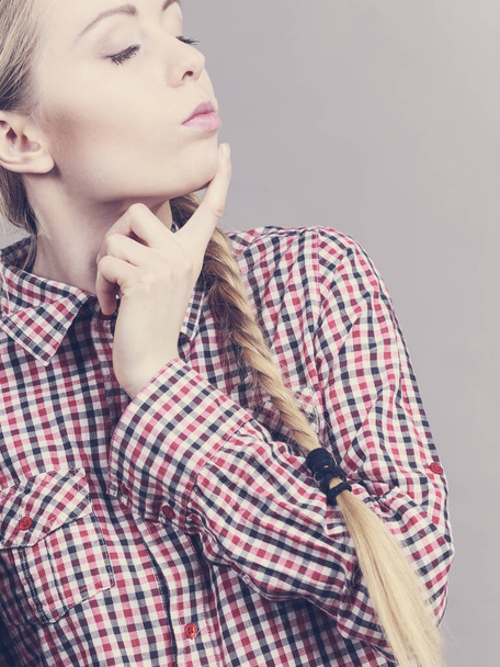Young teenage clever woman thinking intensive about problem solutions. Girl wearing checked shirt - Photo, image