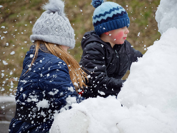 Zimowa zabawa. wesołe dziecko w kapeluszu gra śnieżki 2020 - Zdjęcie, obraz