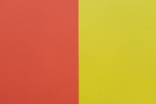 Red and bright yellow cardboard background, with a vertical division, red on the left and yellow on the right - Valokuva, kuva
