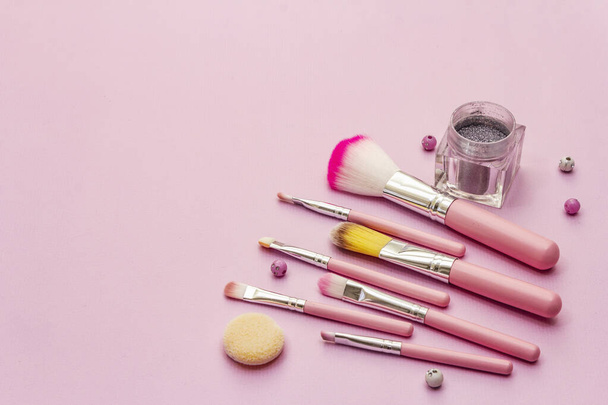 Makeup cosmetic set on pink background. Professional decorative cosmetics, beauty blogger concept - 写真・画像