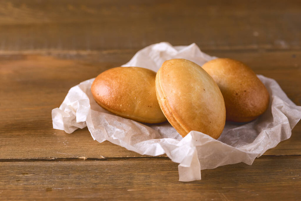 Three Traditional Small Russian Pies on Wooden Background Horizontal - Fotó, kép