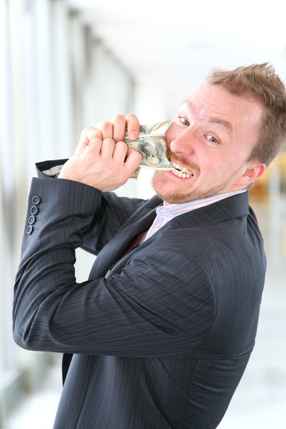 Hungry angry businessman with money - Foto, Bild