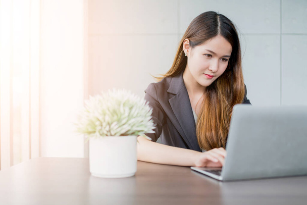 attractive smart and beautiful business asian woman positive thinking and work with laptop in office background - Valokuva, kuva