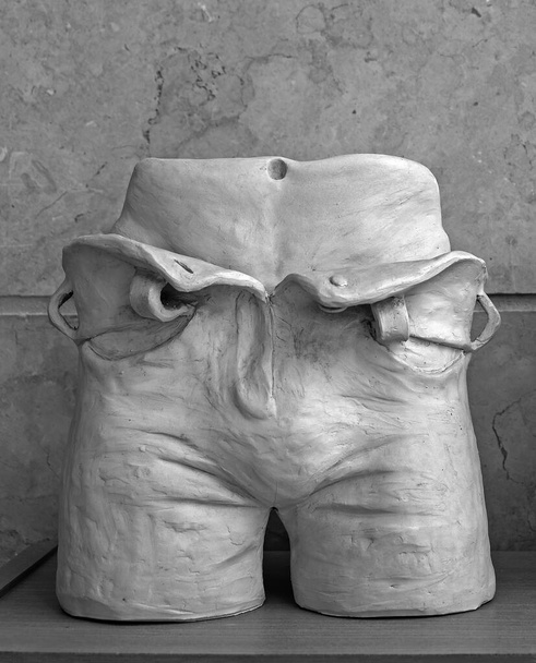 Sculptural image of the middle part of the human body from the belt to the knees in unfastened pants - Photo, Image