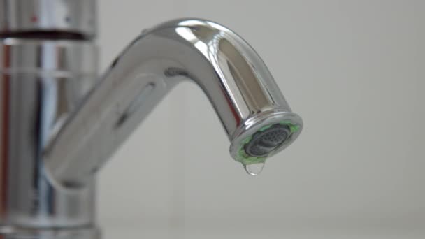 Gros plan d'un robinet coulant avec des gouttes d'eau tombant
 - Séquence, vidéo