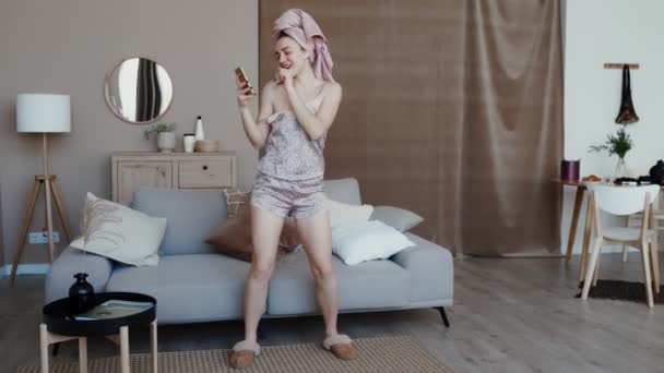 Funny girl dressed in nightwear and home slippers - Filmati, video