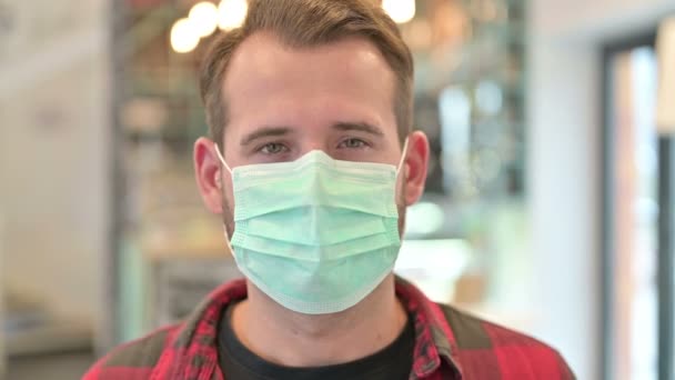 Portrait of Young Man with Face Mask Coughing  - Video