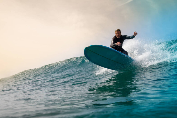 Surfer riding waves on the island of fuerteventura - Fotó, kép