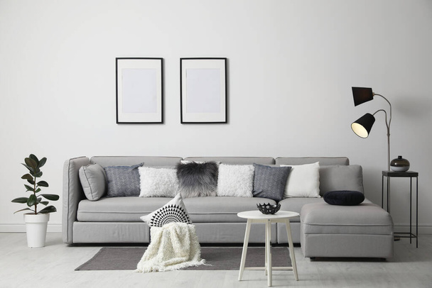 Stylish living room interior with comfortable sofa - Foto, Bild