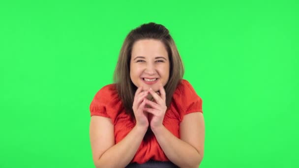 Portrait of cute girl looking with tenderness with folded arms in front of her. Green screen - Imágenes, Vídeo