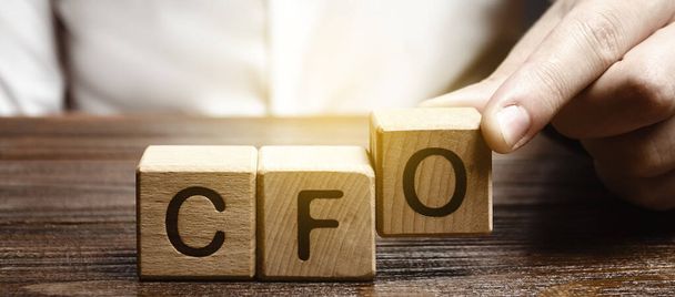 A man makes the word acronym abbreviation CFO. Chief Financial Officer. Financial management in business and company. Risk. Development and growth. Appointment to a new post, promotion. - Foto, Bild