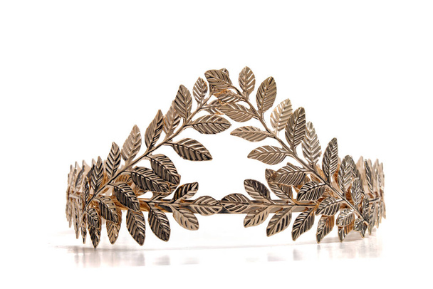 Close up view of a golden leaf tiara headband isolated on a white background. - Photo, Image