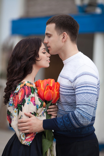Happy couple with spring bouquet tulips - 写真・画像