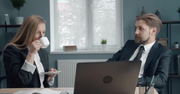 Two partners having coffee break during workday - Filmati, video