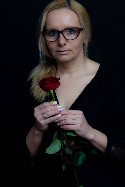 A woman with a rose. Portrait. Women's Day. 8 march - Photo, Image