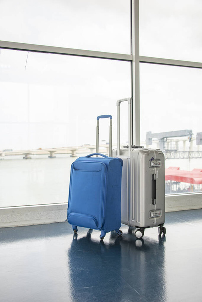 Suitcases at  Ferry port near window. Traveling on vacations in summer concept. - Foto, Imagem