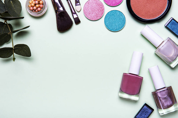Set of decorative cosmetics on a pastel green background. Flat lay, top view. - Photo, Image