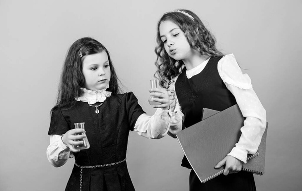 children study chemistry lab. school kid scientist studying science. back to school. curious girls with folder. curious about results. little smart girls with testing flask. biology education - Foto, Bild
