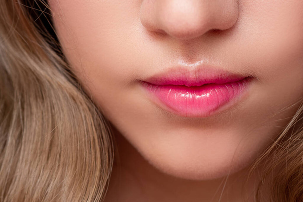 Beautiful natural lips with a pink tinge. Lip balm and lipstick, - Foto, Bild