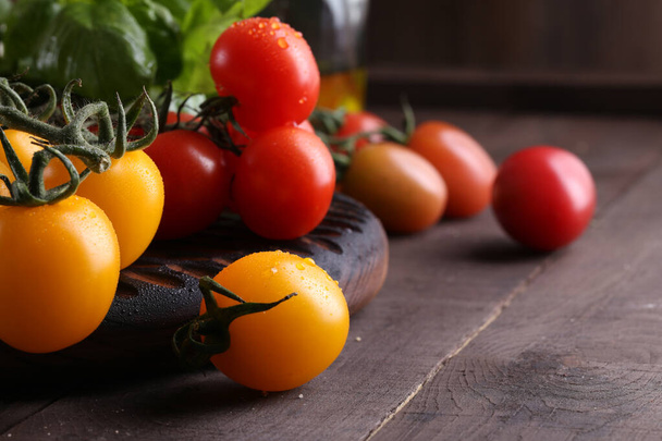 fresh organic cherry tomatoes on a wooden table - Фото, зображення