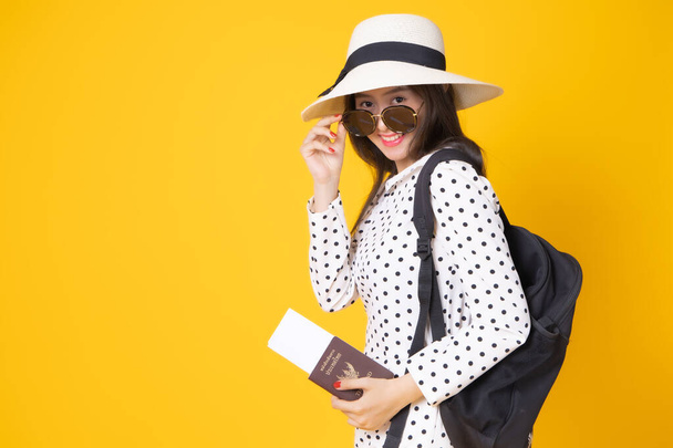 Tourist woman in summer casual clothes.Asian Smiling woman .Passenger traveling abroad to travel on yellow background.She going to summer vacation.Travel trip funny  on holiday. - Fotó, kép