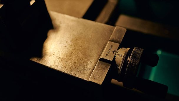 Control detail on a manual lathe. Metal processing in production.Close-up. - Fotó, kép