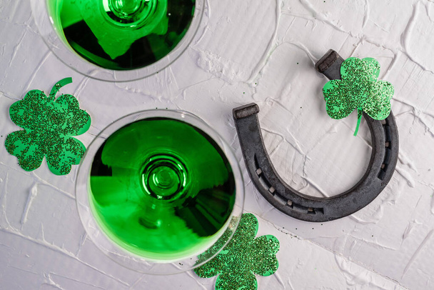 St. Patrick's Day concept. Old horseshoe and clover leaf - Photo, Image