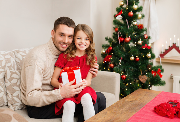 Smiling father and daughter holding gift box - Photo, Image