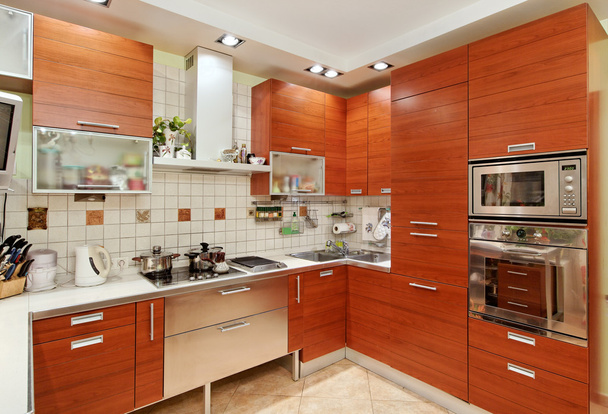 Kitchen interior with wooden furniture and build in utensils - Φωτογραφία, εικόνα
