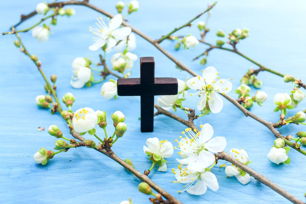 Cross of god, flowering branches of wood on the table - Photo, Image