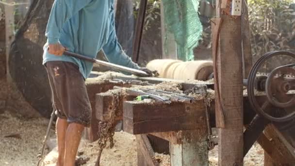 Workers forming long drum By using a rotating motor and using sharp object for forming - Footage, Video