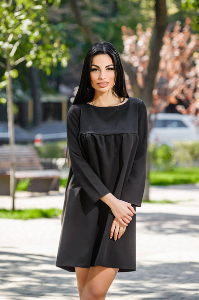 Attractive brunette in dress outdoors in spring - Valokuva, kuva
