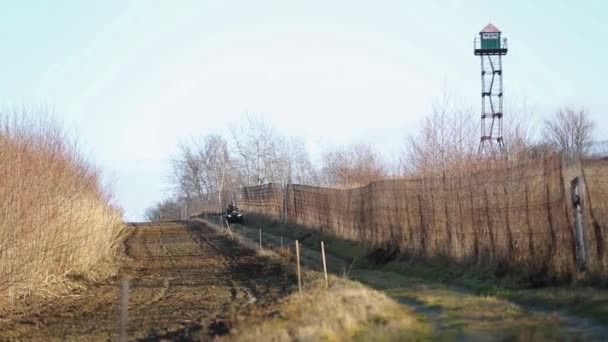 State border with a fence and plowed land. - Footage, Video