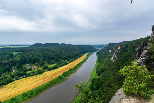 The river Elbe in Saxon Switzerland near Dresden on a cloudy day - Fotografie, Obrázek