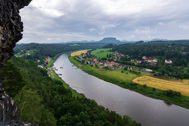 The river Elbe in Saxon Switzerland near Dresden on a cloudy day - Fotografie, Obrázek