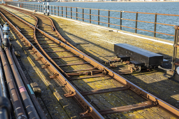 Southend Pier Railway. Two railway tracks merge together near water, Southend-on-Sea, UK. - Photo, Image
