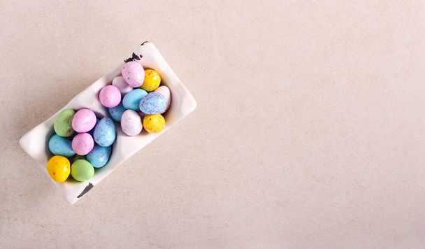Chocolate sweet Easter candy eggs on stone surface - Foto, imagen