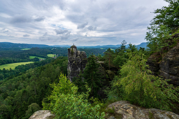 Rock in Saxon Switzerland near Dresden with clouds and fog on a cloudy day - Foto, afbeelding