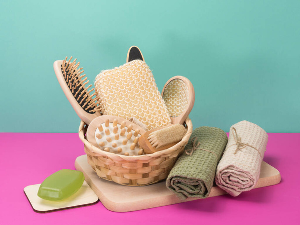 Bath set, soap and towels on a pink and turquoise background. Accessories for swimming. - Photo, Image