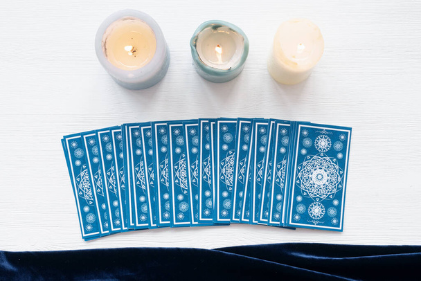 Tarot cards on the white wooden table background. - Foto, imagen