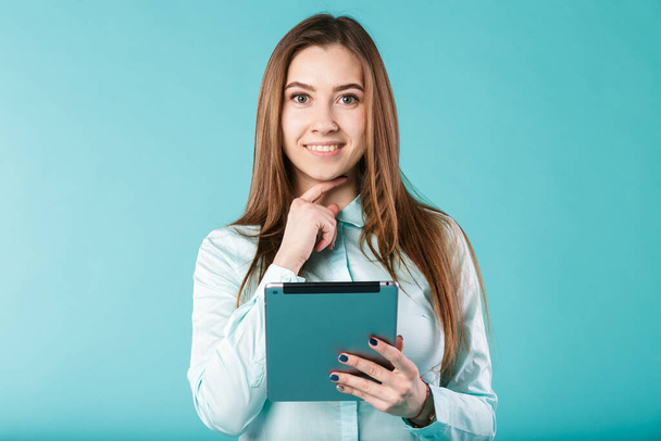 She always connected. Woman using digital tablet computer PC happy isolated on turquoise background. Portrait young caucasian woman worker, teacher, mentoring in shirt office style with tablet in hand - Фото, изображение